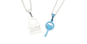 Close-up of stainless steel couple necklaces with a love lock and heart key pendant set