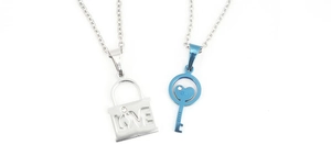 Detail of silver lock and blue heart key pendants with LOVE engraving and crystals