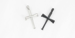 Close-up of polished stainless steel baseball bat cross pendants in silver and black colors