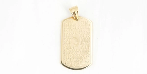 Detailed macro view of gold-plated military dog tag pendant with Ave Maria engraving