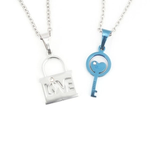 Matching couple necklaces with silver LOVE lock and blue heart key pendants in steel