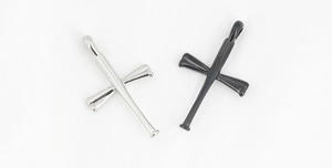 Detailed close-up of crossed baseball bat cross pendants in silver and matte black steel