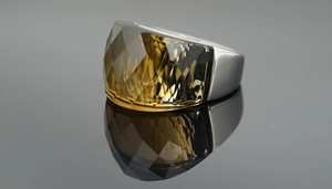 Macro shot of large faceted smoky quartz gemstone on wide polished silver ring band