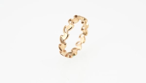 Detail shot of rose gold titanium eternity band with cutout olive leaf pattern