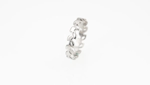 Detailed view of silver titanium steel ring with hollow leaf texture and minimalist design
