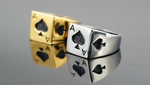 Macro shot of gold and silver stainless steel rings with 3D Ace of Spades engraving