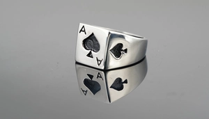 Macro shot of silver stainless steel ring featuring engraved black Ace of Spades detail