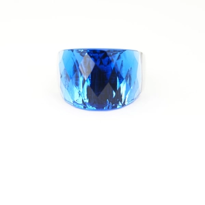 Exaggerated wide band cocktail ring featuring a large faceted blue sapphire gemstone