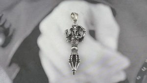 Macro detail of vintage silver Ganesha Vajra pendant with oxidized retro texture
