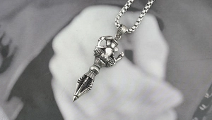 Close-up of vintage Ganesha and Vajra pendant necklace with antique silver finish details