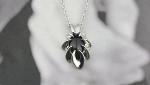Detailed view of silver gothic obsidian pendant with unique claw design and fine chain
