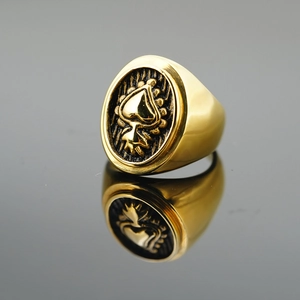 Vintage gold heart signet ring in gothic style for men on reflective dark surface