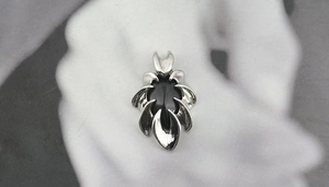 Detailed view of obsidian pendant with silver claw setting and dark gothic design