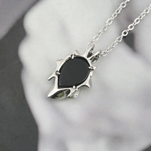 Gothic obsidian pendant necklace with silver thorn frame and polished black stone