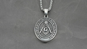 Detailed macro view of vintage silver Freemason compass pendant on a steel chain