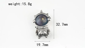 Detailed view of astronaut pendant with dimensions 32.7mm by 19.7mm and blue starry visor