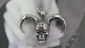 Close-up of gothic ram skull pendant with intricate engravings on a box chain