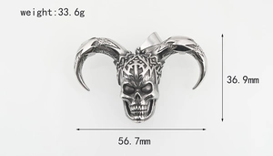 Macro shot of gothic sheep skull pendant with cross emblem and vintage metal texture