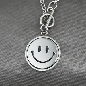 Hip hop titanium steel necklace featuring a rotating double-sided smiley pendant with OT buckle