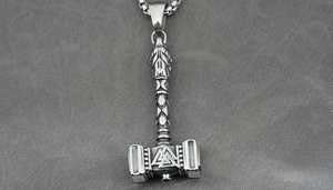 Macro shot of vintage titanium steel Mjolnir pendant with Valknut symbol and box chain