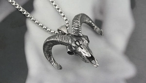 Detailed macro view of vintage ram skull necklace with engraved Ankh symbol
