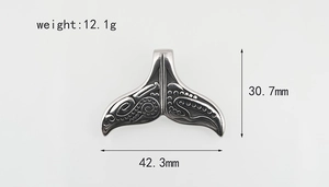 Detailed size map of whale tail pendant showing 42.3mm width and tribal texture
