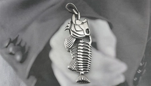 Macro shot of silver titanium steel fish skeleton pendant with detailed bone structure