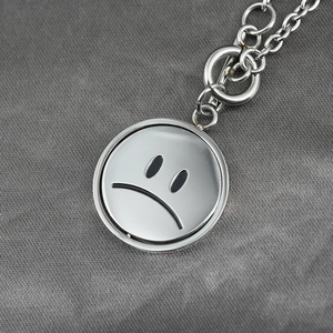 Hip hop silver titanium steel necklace featuring a rotating double-sided smiley face pendant