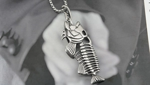 Macro shot of titanium steel fish skeleton pendant with vintage distressed finish