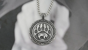 Close-up of vintage titanium steel necklace with Viking bear paw and bison relief detail