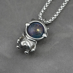 Polished silver astronaut pendant necklace with blue starry globe on a box chain