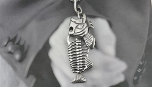 Close-up of vintage titanium steel fish bone pendant necklace with antique finish detail