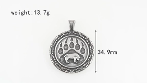 Detail showing 34.9mm Viking bear paw pendant with buffalo silhouette in vintage steel