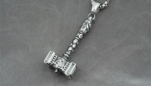 Macro shot of Viking Mjolnir pendant with Valknut symbol on stainless steel chain