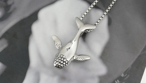 Detailed close-up of a titanium steel whale pendant on a box chain for men and women