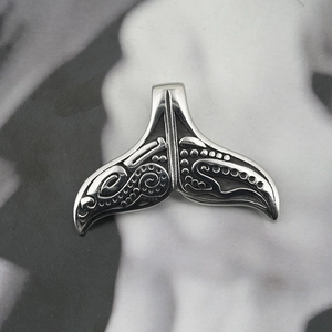 Tribal style titanium steel whale tail pendant with intricate engraved wave patterns