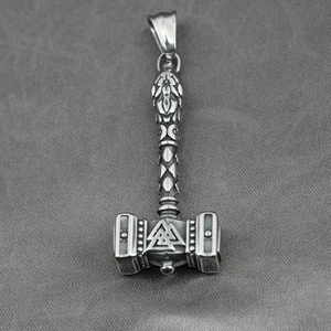 Silver Viking Mjolnir pendant necklace with Valknut symbol and Celtic engravings on gray fabric