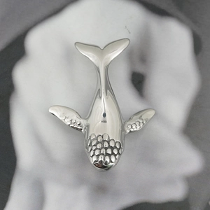Polished silver whale pendant necklace in titanium steel with detailed dot texture