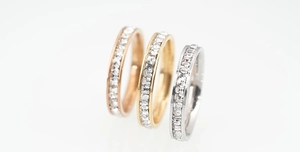 Close-up of channel-set square zircon rings in gold, rose gold and silver finishes