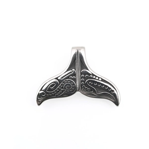 Polished titanium steel whale tail pendant with retro oceanic totem relief on white background