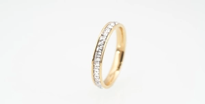 Detailed close-up of 18K gold-plated titanium ring with channel-set square white zircons