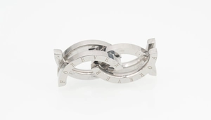 Macro detail of interlocking silver steel rings featuring a FOREVER engraved inscription