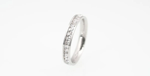 Macro view of silver titanium steel eternity ring with square cut diamonds inlay