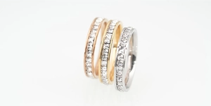 Detailed view of three-color titanium steel rings with square-cut channel-set cubic zirconia