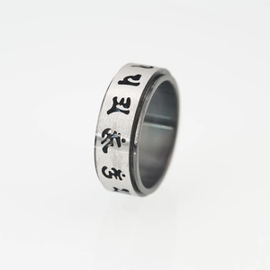 Spinner ring made of brushed stainless steel with engraved black religious symbols