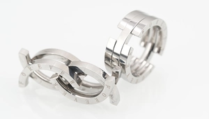 Detailed close-up of interlocking silver rings with Forever engraving on polished surface