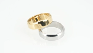 Macro view of gold and silver titanium steel rings with minimalist beveled edge design