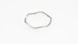 Nahaufnahme eines gewellten Titanstahlrings in Silber mit glänzendem Finish