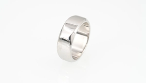 Polished stainless steel ring with flat surface and beveled edges on white background