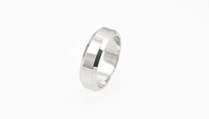 Macro detail of silver titanium steel ring with polished edges and brushed metal surface